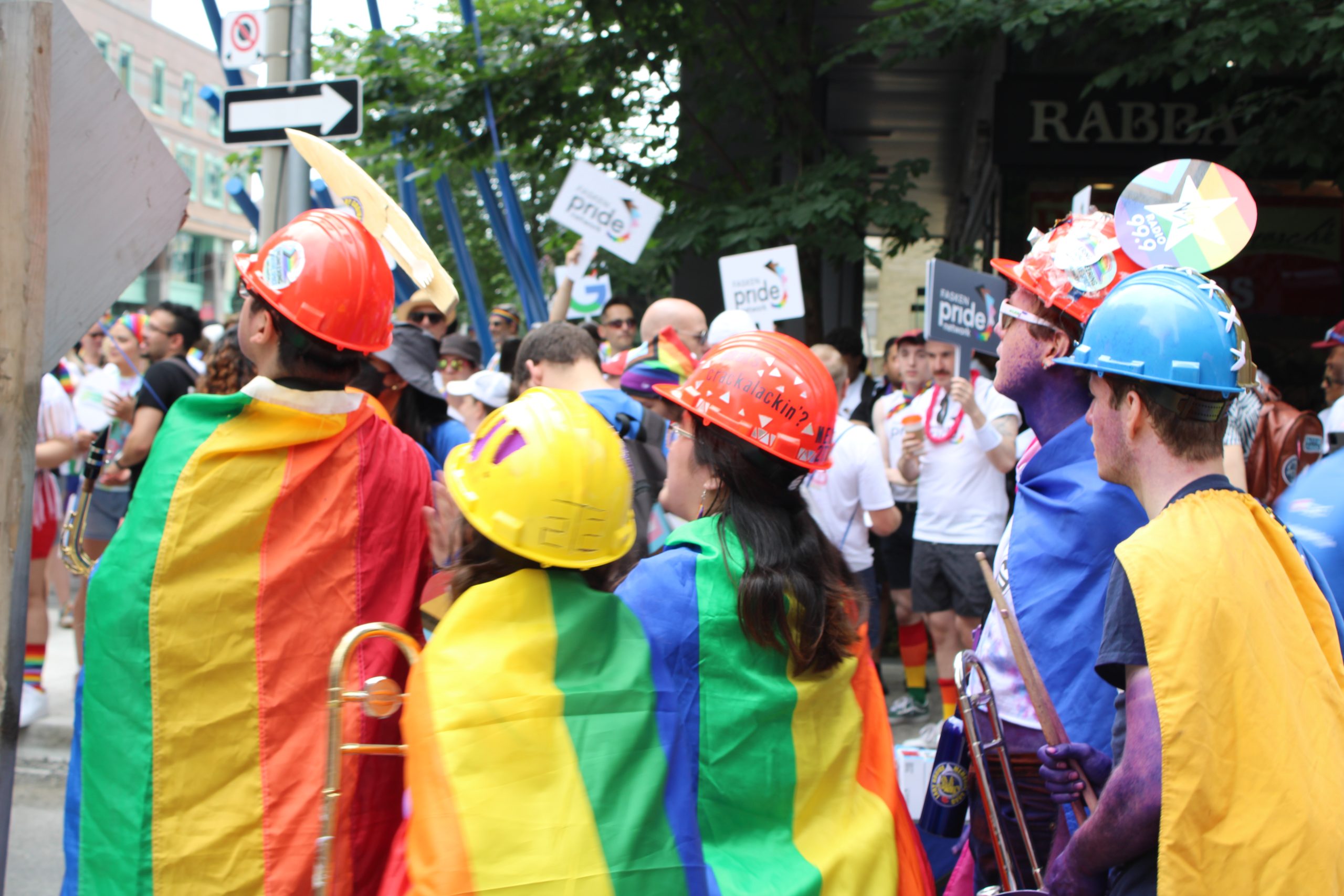 Engineering students wearing hard hats and pride flags during the 2023 Pride Parade. Photo by Lily Kim and Emaan Fatima