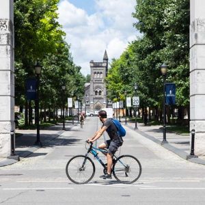 Student riding his bike near campus