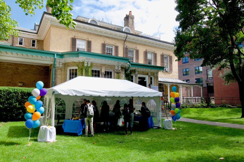 Image shows Cumberland House, the location of the Centre for International Experiences. In front of the house is a tent, with students and balloons.